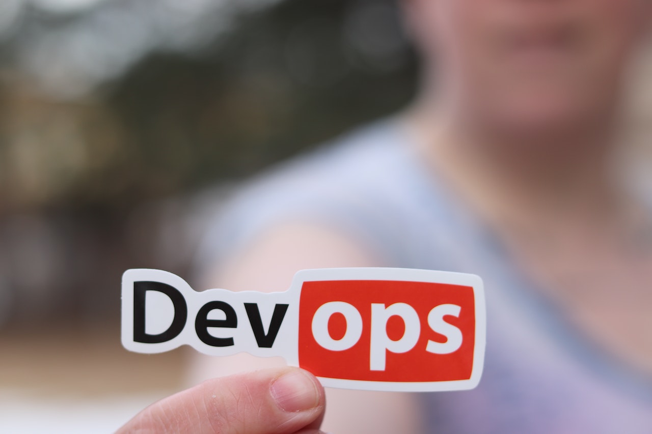 Person holding DevOps sticker