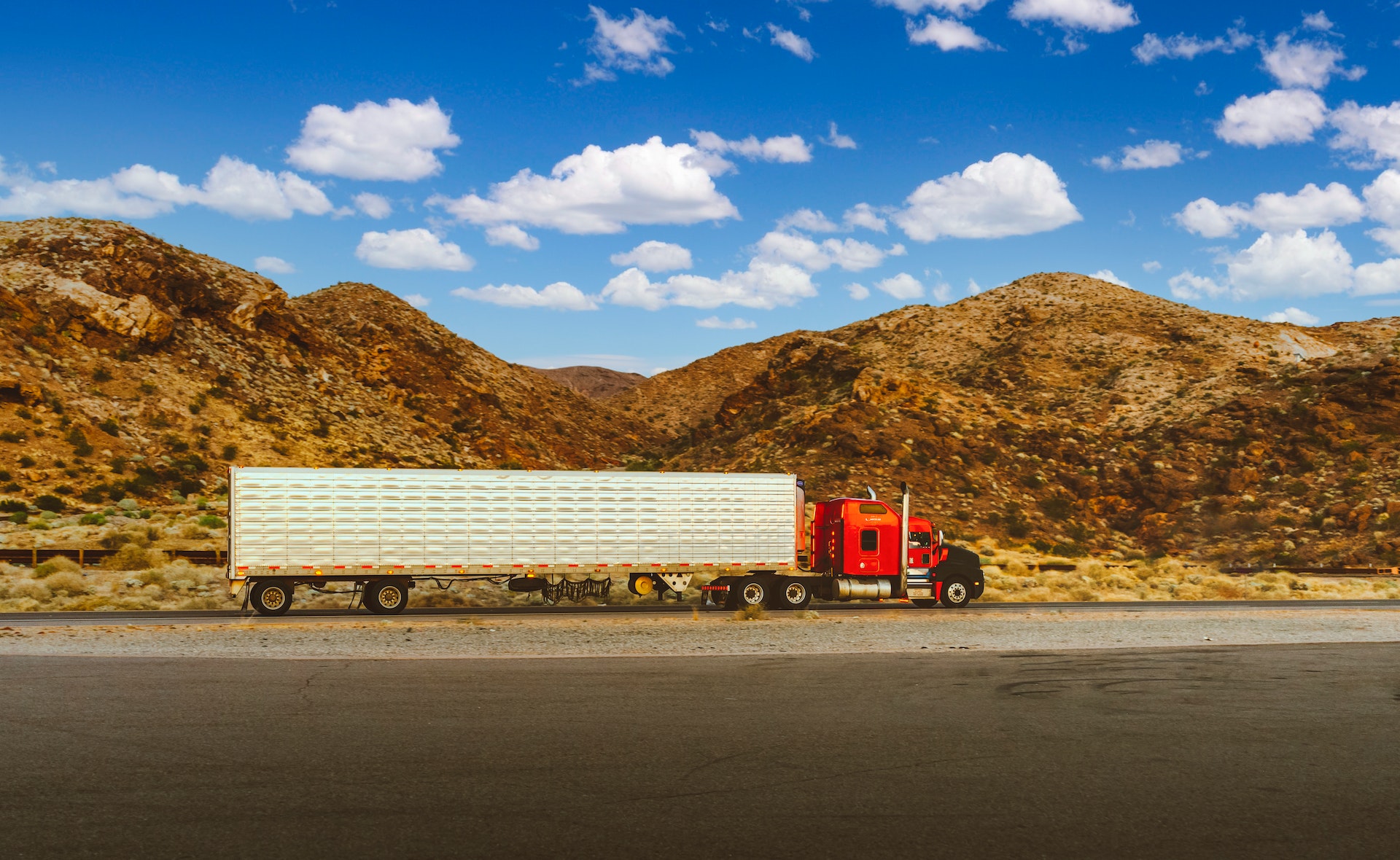 Illustrating application modernization service case study is an image of truck pulled over to the side of the road with mountains in the background