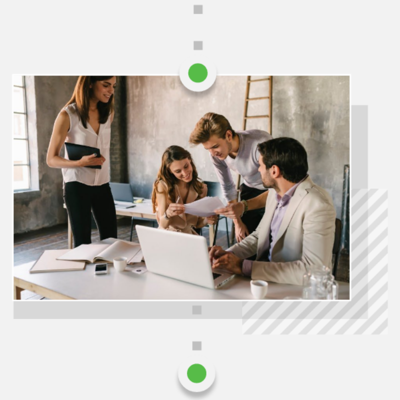 Four young professionals reviewing notes of agile development 