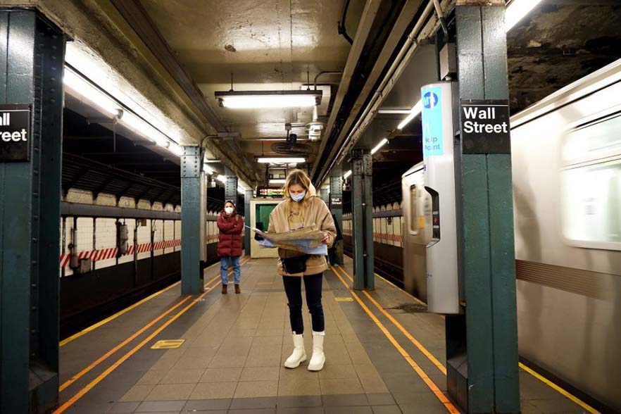 Young tourist checking a map as she travels through New York