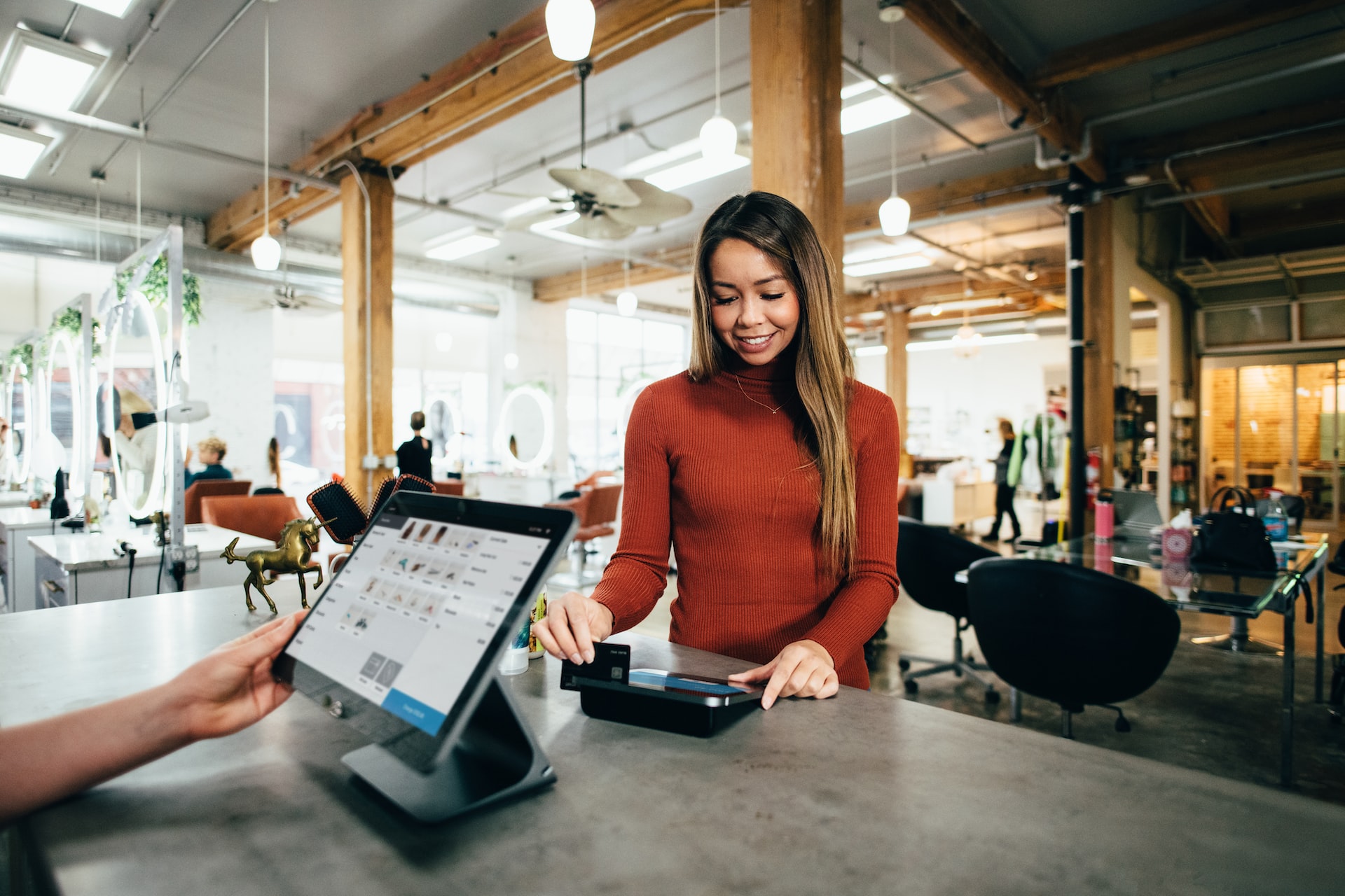 Female customer enjoying intuitive UX experience while checking out at store