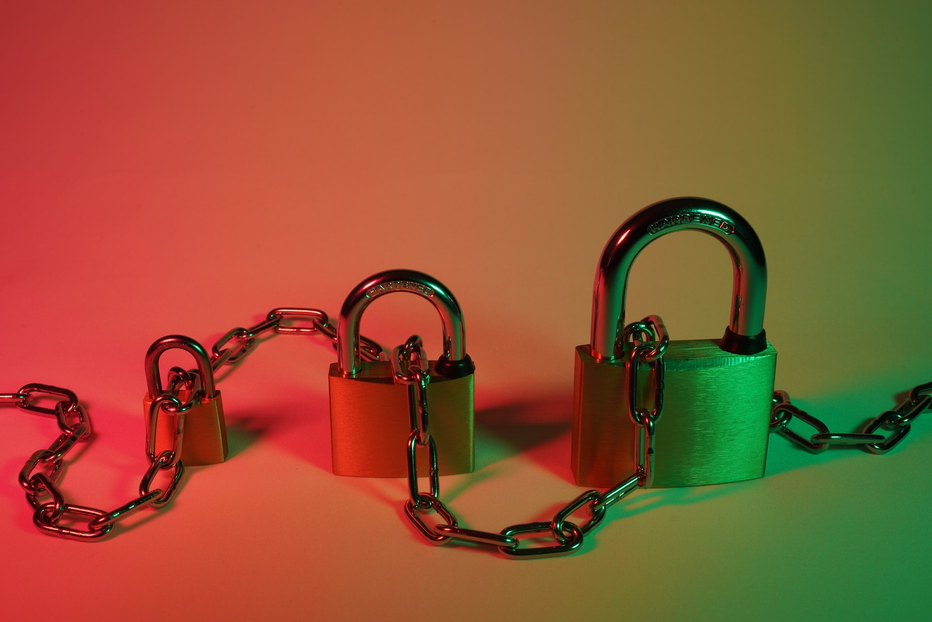 Cloud security represented by three differently-sized locks and a chain in-between them