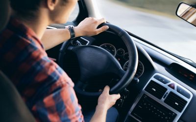 Young man driving a rental car