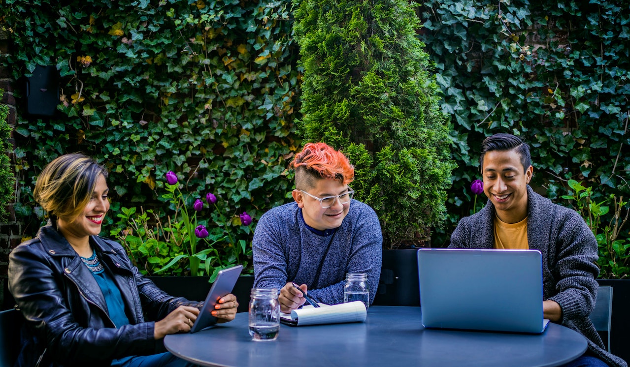 Three young professionals reviewing data from a data lake