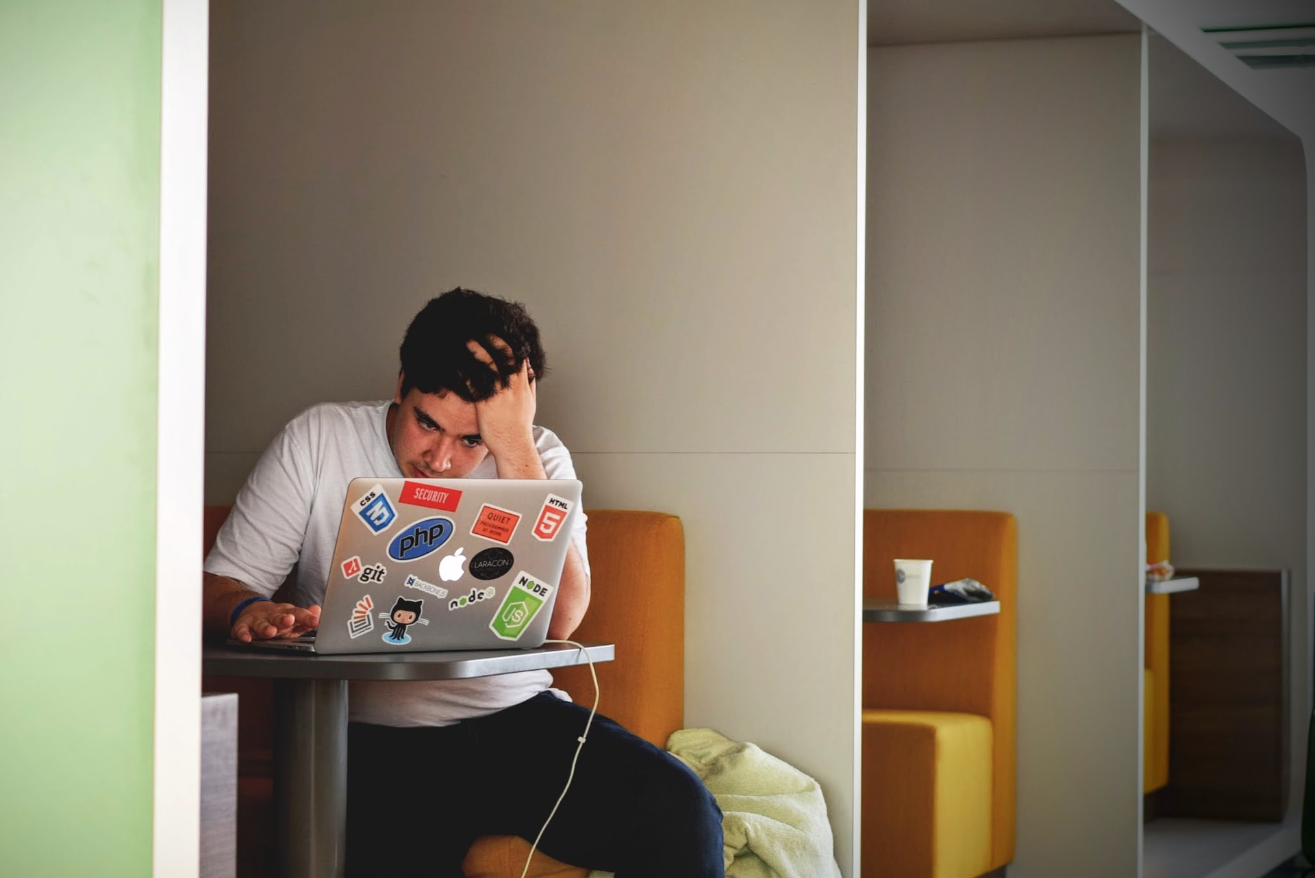 Male user at cafeteria table frustrated at bad UX on web application