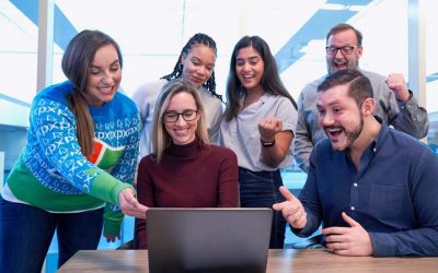 Young professionals viewing new feature on laptop at the end of an agile development sprint