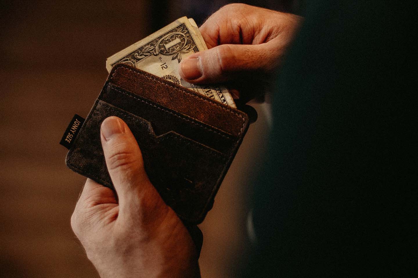 Business executive taking money out of his wallet