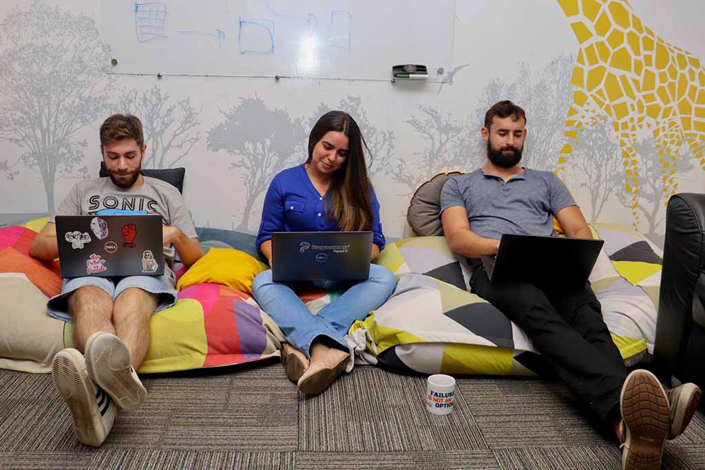 Dedicated team working on their laptops in an office