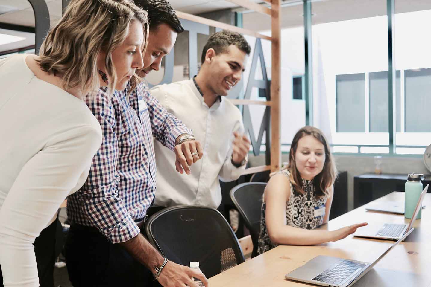 Dedicated teams and internal teams working together in an office