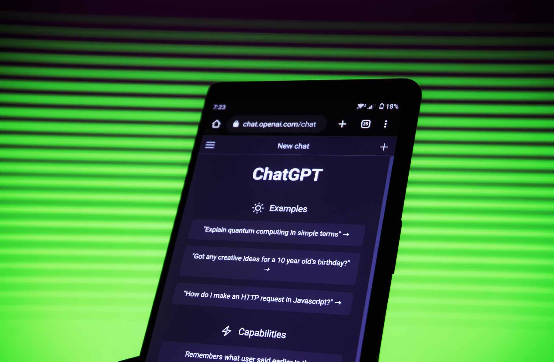 ChatGPT, one of the biggest application modernization trends in 2023, pulled up on someone’s phone with a neon green background