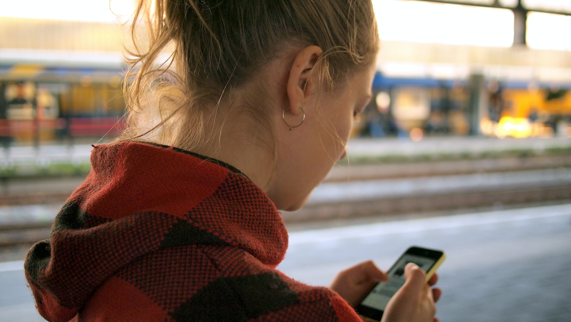 Woman browsing alerts and notifications system on her phone