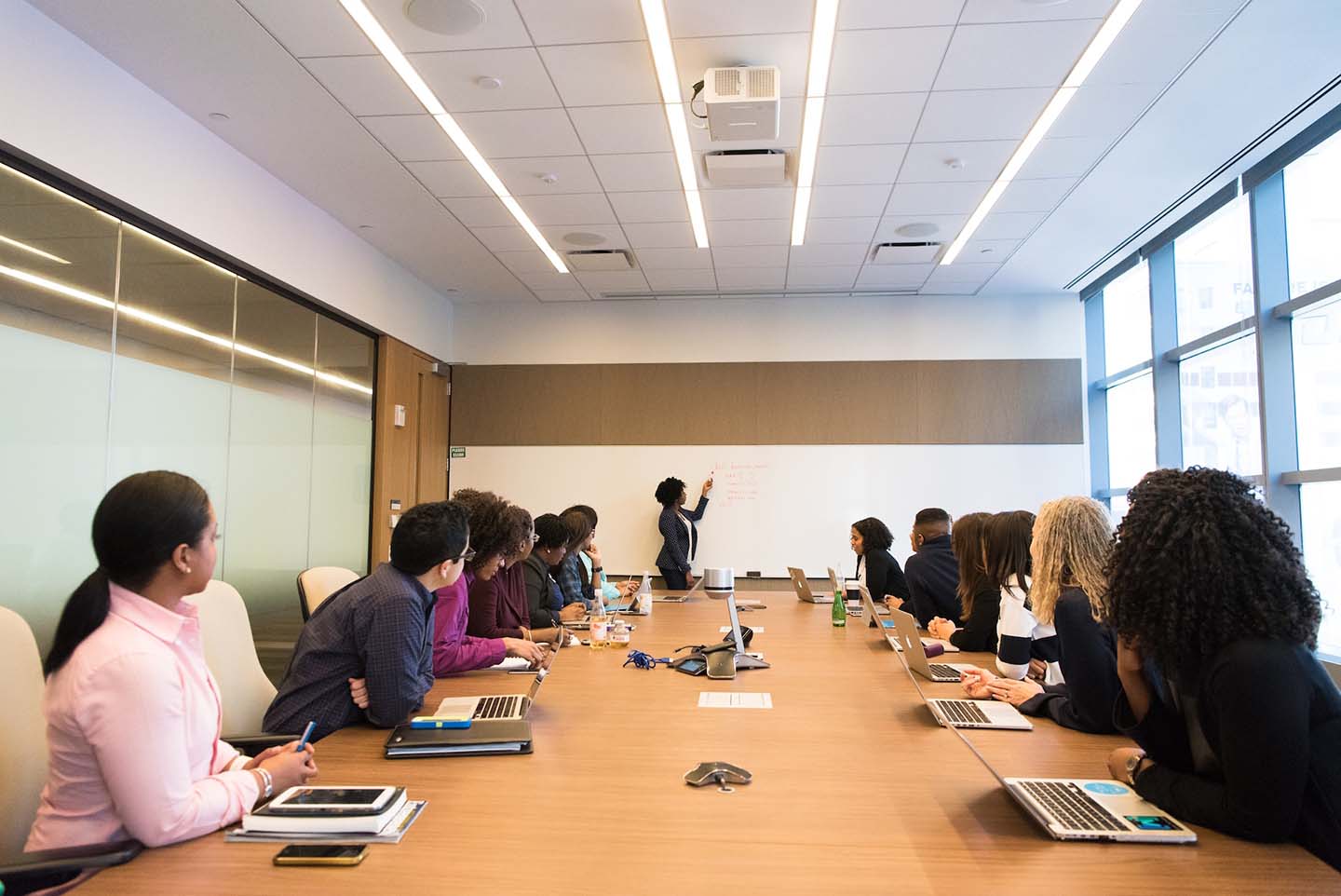 Professional at whiteboard leading an employee training on ChatGPT