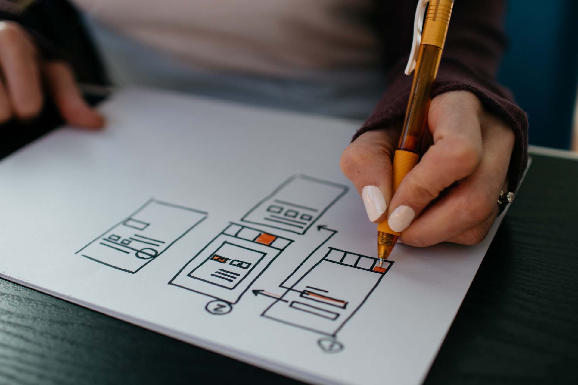 Young professional sketching UX improvements