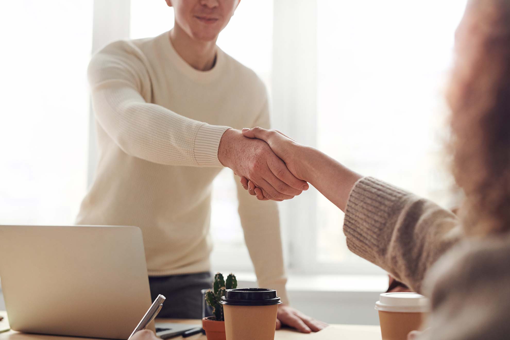 CIO standing up to shake hand of new digital product development partner