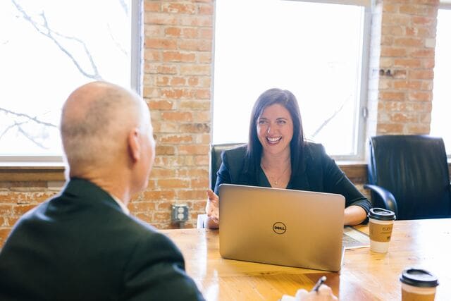 Two professionals in a conference room collaborating on their generative AI strategy