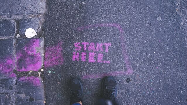 The words “Start Here” written in chalk on a sidewalk, symbolic of getting started using generative AI